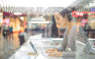 Artificial Intelligence Woman sits at computer.