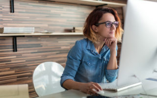 Woman learning in front of a laptop..